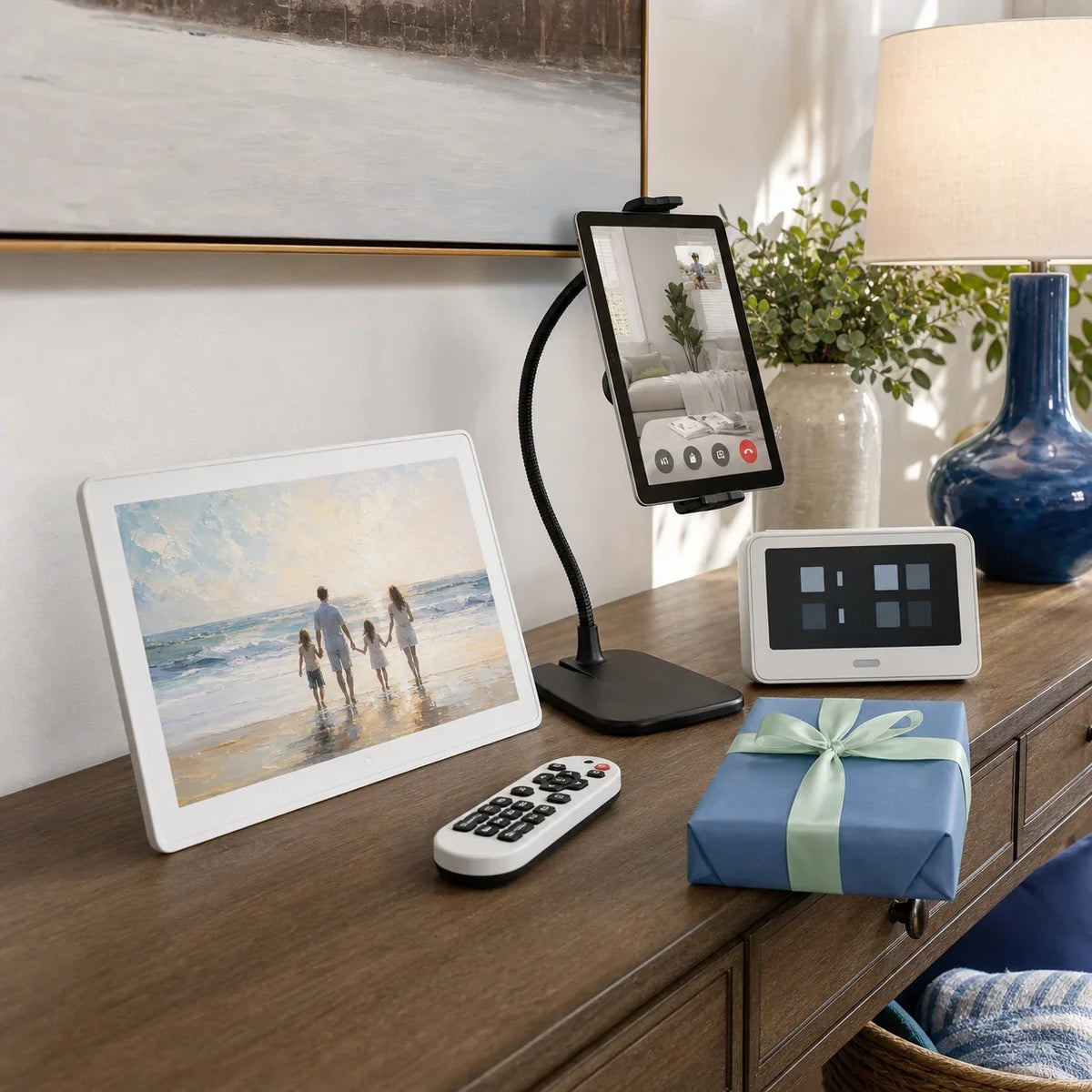 Digital photo frame, tablet stand, clock, and remote on a home console